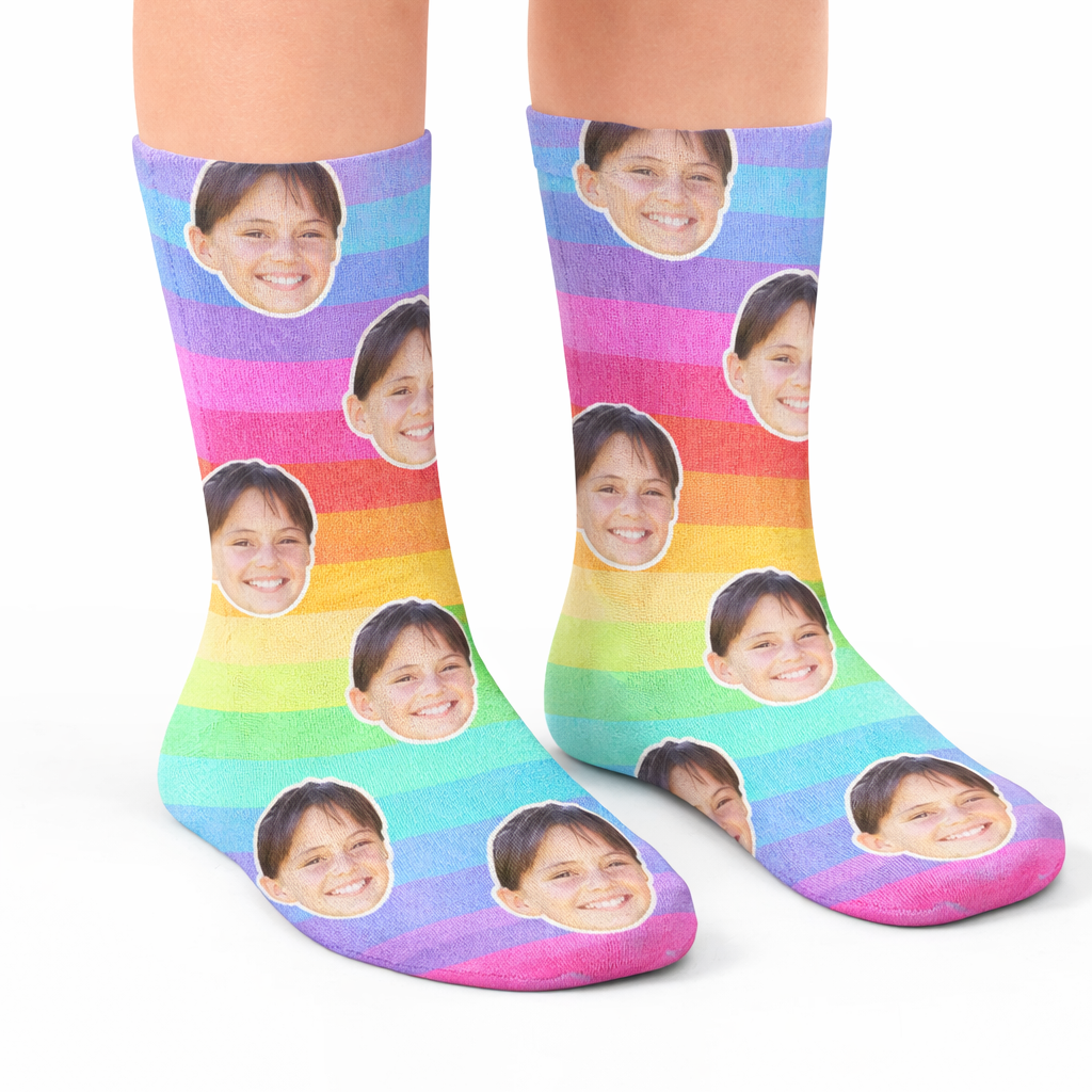 Colorful socks with multiple faces printed on them worn by a person.