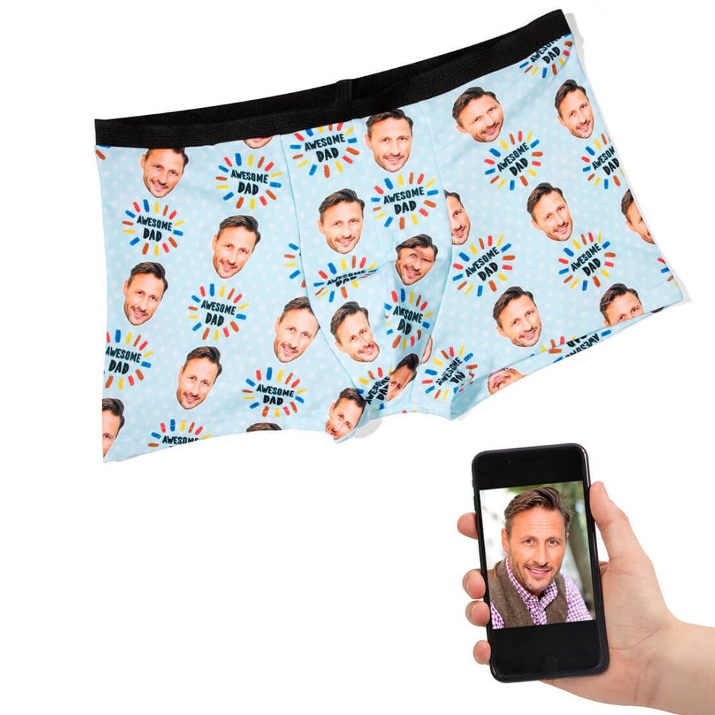 Personalized underwear with a pattern of a man's face and a hand holding a phone displaying the same face.